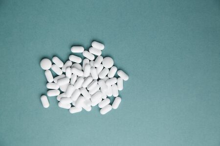 Virus protection and 2019-ncov. Layout of Flatley tablets. A pile of white tablets on a blue background is isolated.の写真素材