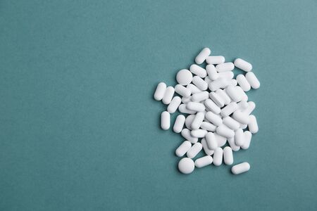 Virus protection and 2019-ncov. Layout of Flatley tablets. A pile of white tablets on a blue background is isolated.の写真素材