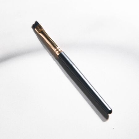 Light background with highlights for the site. A tool for a makeup artist. Makeup brush. Black plastic eyebrow brush. の写真素材