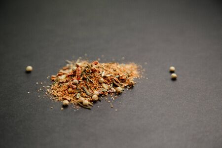 Cloves, garlic and pepper for seasoning. Spices on a black background. 