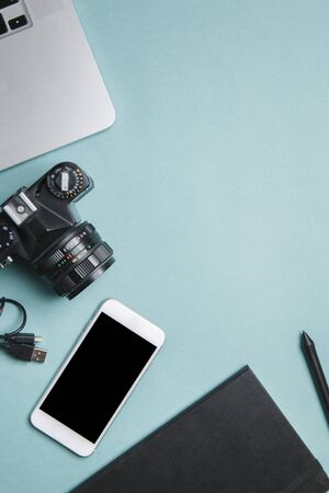 Flatley with camera, laptop and phone. Minimalist layout of the photographer on a bright background. の写真素材