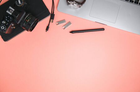 Flatley with camera, laptop and phone. Minimalist layout of the photographer on a bright background. の写真素材