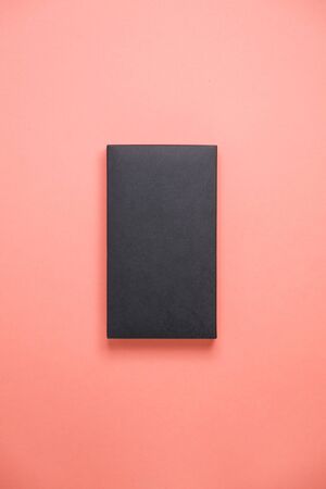Minimalistic blank for design. Black gift box on pink background. の写真素材