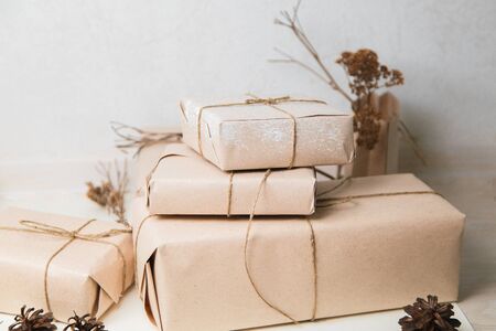 Set of boxes on white background. Gifts in Kraft packaging with ribbon.の写真素材