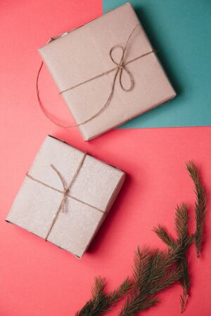 Set of boxes on a double background of pink and green. Gifts in Kraft packaging with ribbon.の写真素材