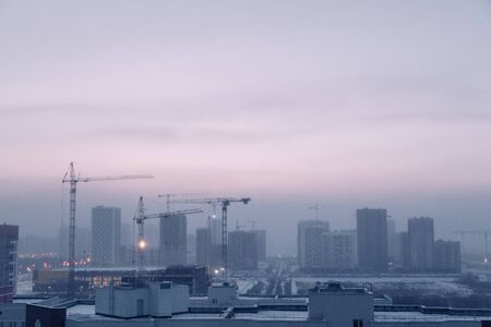  Panorama of construction at sunset. Construction of a residential complex with cranes.の写真素材
