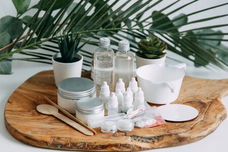 Bottle of natural cosmetics Flatley. Ecological cosmetics in jars with greens. の写真素材