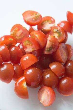  A handful of sliced tomatoes for the salad. Ripe cherry tomatoes in a bowl.の写真素材