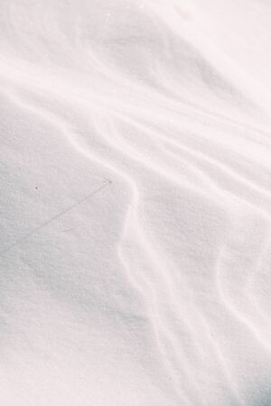 The wavy texture of fresh snow. White drifts and the sun.の写真素材