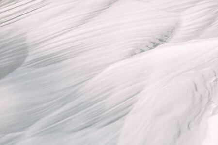 The wavy texture of fresh snow. White drifts and the sun.