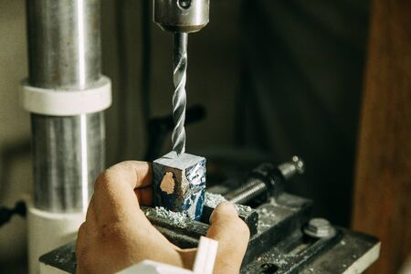 Drilling holes on wood parts. Shop with machines for wood processing.の写真素材