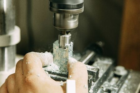 Drilling holes on wood parts. Shop with machines for wood processing.の写真素材