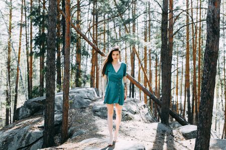 Forest nymph, portrait in the sun. Beauty portrait of a sexy girl. Beautiful girl in a Sunny spring forest.の写真素材