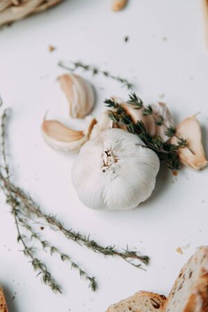  Flatley layout for cooking. Garlic cloves on a white background. Peeled garlic with salt, oil and thyme.の写真素材