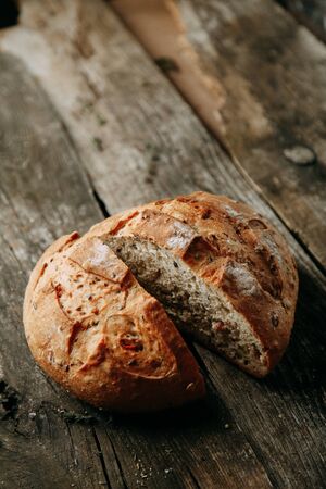 Baking on a towel with garlic and oil. A loaf of white rye bread. Sliced bread on a wooden...