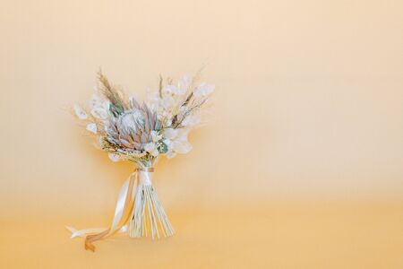 Stylish bouquet for a wedding in the style of finart. Fall bride's bouquet. Floristics of dried flowers. の写真素材