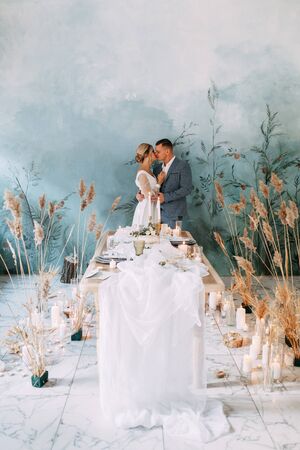 Wedding couple in an autumn decor. Ceremony in the style of fine art in the room. Wedding ceremony in the interior Studio.の写真素材