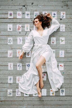 Portrait of the bride. Morning of the bride in a boudoir dress. The girl is lying on the floor.の写真素材