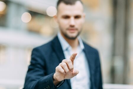 Holds and shows direction and presentation. Hand and finger of a business man in the office, profit growth.の写真素材