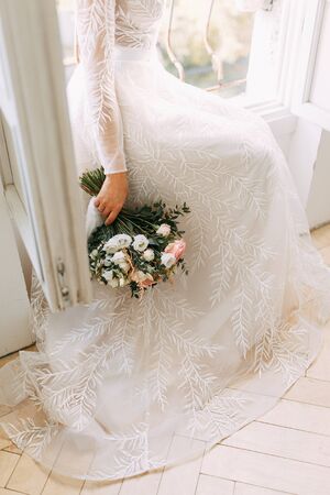 Intimate parts of the body, the atmosphere of the occasion. Wedding shoes, dress details and hands. の写真素材