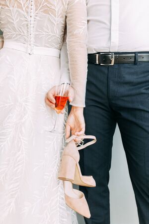 Intimate parts of the body, the atmosphere of the occasion. Wedding shoes, dress details and hands. の写真素材