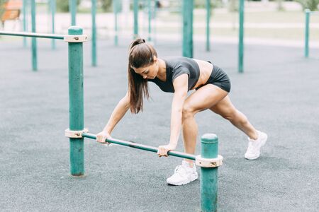 Push-UPS, workout and plank on the street. Beautiful athletic girl on the Playground. Push-UPS, workout and plank on the street.の写真素材