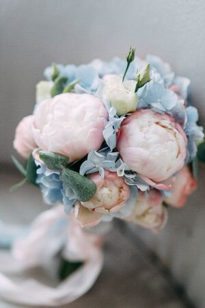 Printing and decor for a wedding with flowers. Modern Bridal bouquet in hand. 