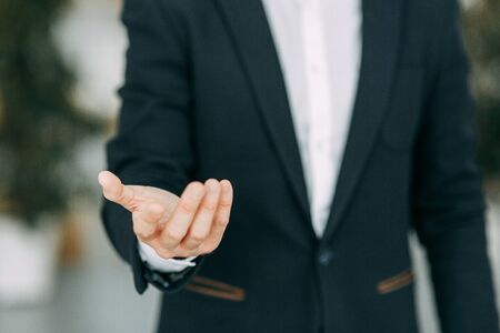 Hands of a businessman to design with a neutral photon. Okay, high five, palms and a successful man.