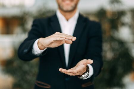 Hands of a businessman to design with a neutral photon. Okay, high five, palms and a successful man.の写真素材