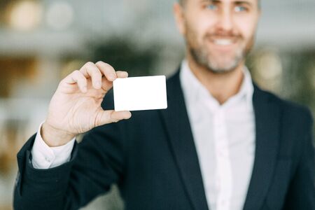 Credit card in the businessman's hand. Rod designer, cut out the background.の写真素材