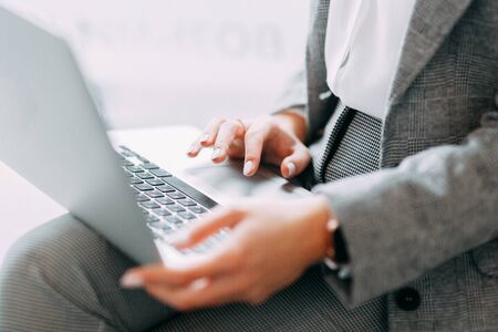 Hands with a laptop at work. Blogger at the coffee shop. White screen for designers. Business girl.の写真素材