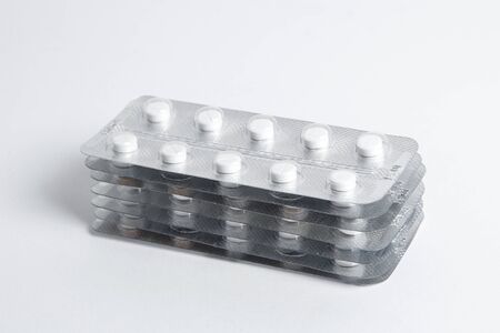 Set of blister packs of pills on white background. Pack of pills in a pile.