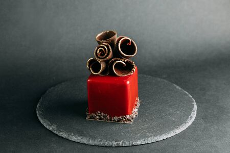 Berry Cakes on a black stone background, author's desserts and serving. Chocolate, berries and cream. The design for the websiteの写真素材