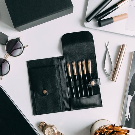 Brush brow and makeup artist in the set. Black and white sets. Flatley layout for blogger. Minimalism on the table, gold brushesの写真素材