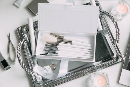 Brush brow and makeup artist in the set. Black and white sets. Flatley layout for blogger. Minimalism on the table, gold brushesの写真素材