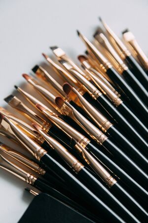 Brush brow and makeup artist in the set. Black and white sets. Flatley layout for blogger. Minimalism on the table, gold brushesの写真素材