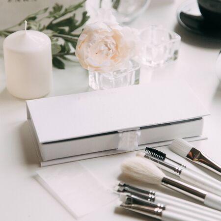 Brush brow and makeup artist in the set. Black and white sets. Flatley layout for blogger. Minimalism on the table, gold brushesの写真素材