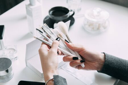 Brush brow and makeup artist in the set. Black and white sets. Flatley layout for blogger. Minimalism on the table, gold brushesの写真素材