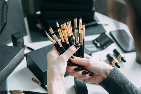 Brush brow and makeup artist in the set. Black and white sets. Flatley layout for blogger. Minimalism on the table, gold brushesの写真素材