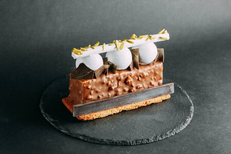 Berry Cakes on a black stone background, author's desserts and serving. Chocolate, berries and cream. The design for the websiteの写真素材