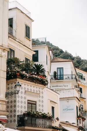 Amalfi coast in Italy, the most beautiful city. Streets and old architecture, narrow passages, shops and cafes. View from the sea and above. Panoramic view of the mountain slopesの写真素材