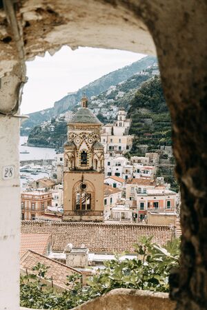 Amalfi coast in Italy, the most beautiful city. Streets and old architecture, narrow passages, shops and cafes. View from the sea and above. Panoramic view of the mountain slopesの写真素材