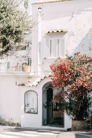 The coast of Positano, Amalfi in Italy. Panorama of the evening city and the streets with shops and cafes. Houses by the sea and the beach. Ancient architecture and temples. View from a postcard on topの写真素材