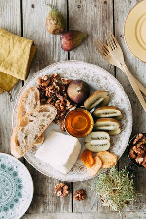 Flatley cheese plate with figs. Snacks for the company. Set of cheeses on a plate with honey and...