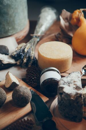  Layout of flatlays from home-made cheeses. Set of cheeses on a wooden Board with wine.の写真素材