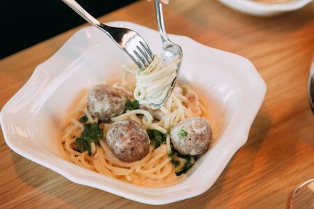 Pasta with cutlets and tomato sauce. Macaroni with meat and spices in the restaurant.の写真素材
