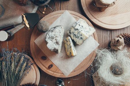 Composition with wine and Flatley cheese. Cheese with a blue noble mold on a wooden Board. の写真素材