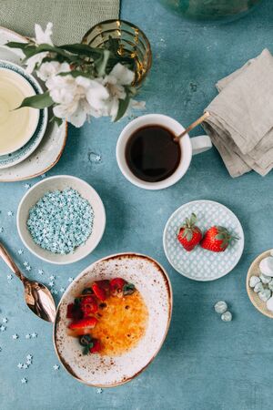 CrÃ¨me brÃ»lÃ©e with chocolate dessert with flowers. Foodstyling with tea on wooden background.の写真素材