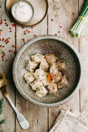 dumplings with potatoes, cheese, berries, compositions for the menu of the restaurant, decorated with greens and sauceの写真素材
