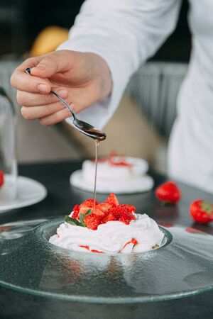 the preparation of the dessert Pavlova with strawberries and in the supply of liquid nitrogenの写真素材